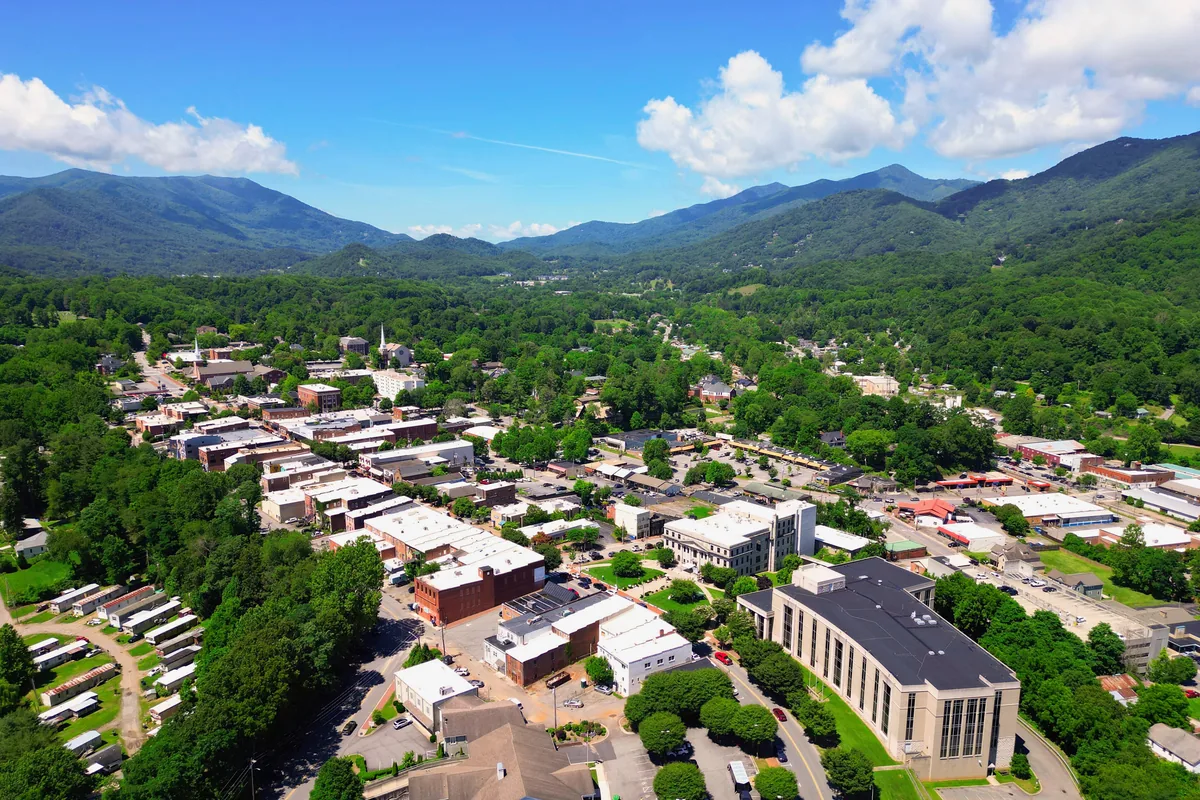 Aerial view of downtown Waynesville, the Haywood County seat, with forested mountains rising behind the valley