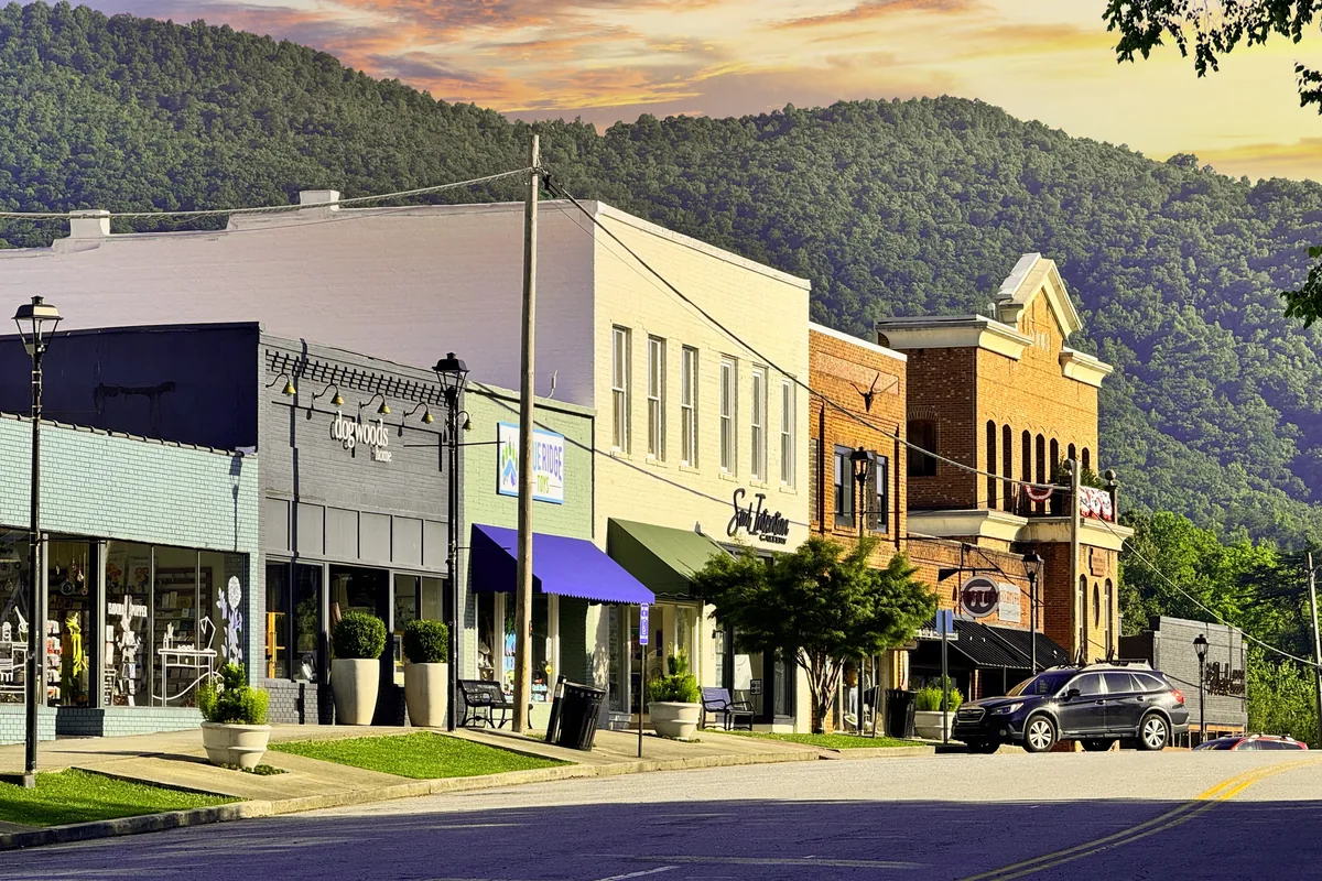 Downtown Clayton storefronts in Rabun County, Georgia, with a forested mountain ridge rising behind them
